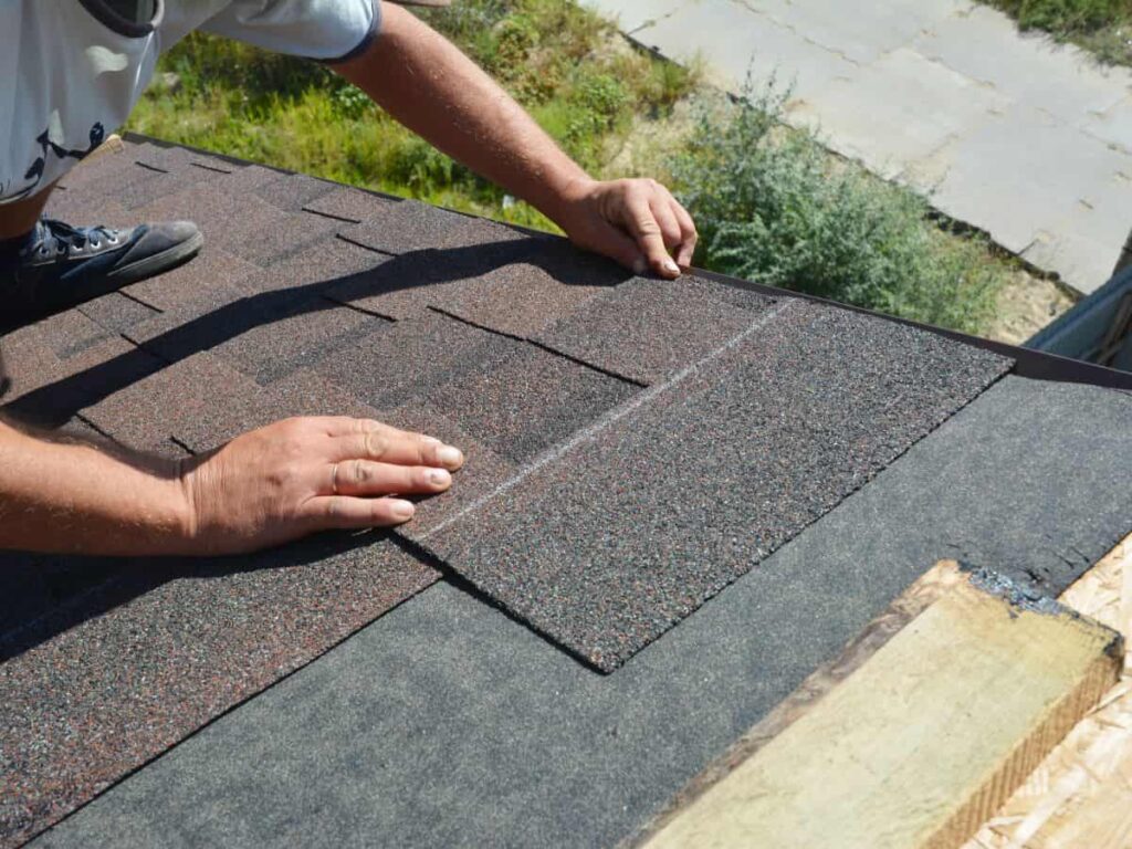man installing asphalt shingle roof